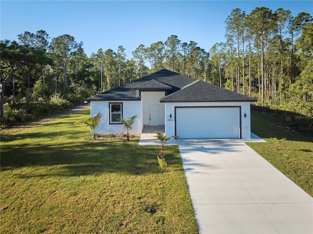 view of front of home with a front yard and a garage