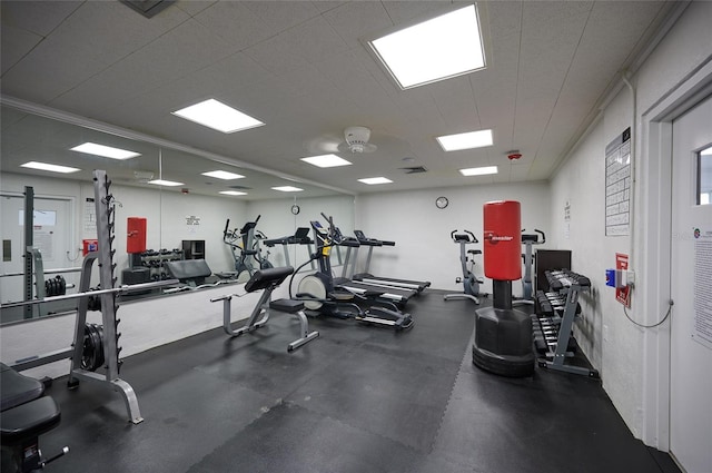 workout area featuring ornamental molding