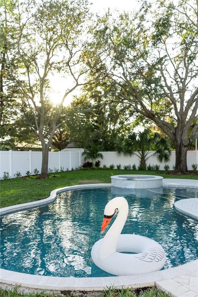 view of pool with an in ground hot tub