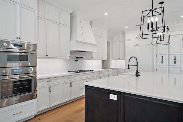kitchen with stainless steel appliances, custom range hood, and white cabinets