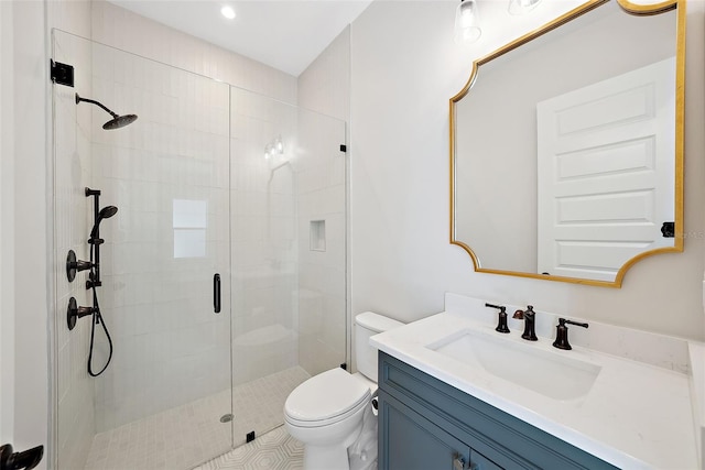 bathroom featuring vanity, an enclosed shower, and toilet