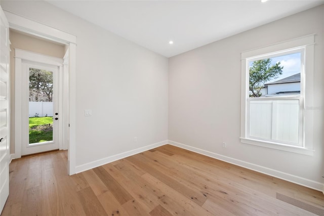 empty room featuring light hardwood / wood-style flooring and a healthy amount of sunlight