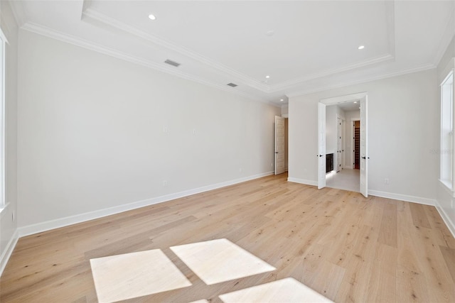 unfurnished room with ornamental molding and light wood-type flooring
