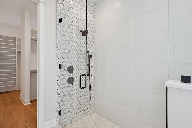 bathroom featuring a shower with door and hardwood / wood-style floors