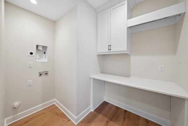 washroom featuring hardwood / wood-style floors, hookup for a washing machine, cabinets, and hookup for an electric dryer