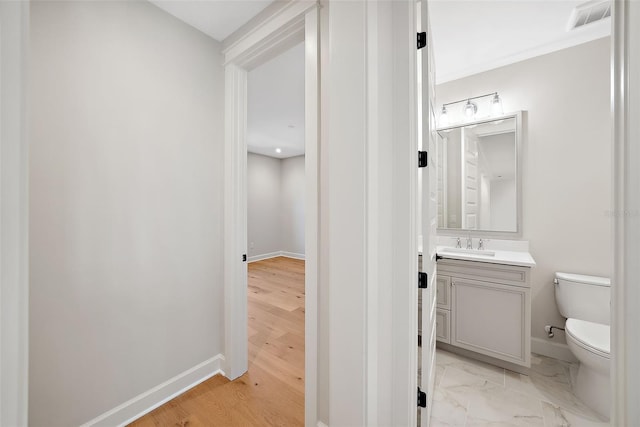 bathroom featuring vanity, hardwood / wood-style floors, and toilet