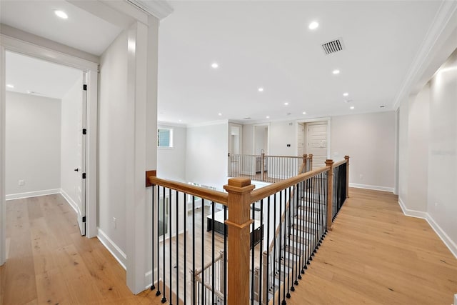 corridor with crown molding and light hardwood / wood-style flooring