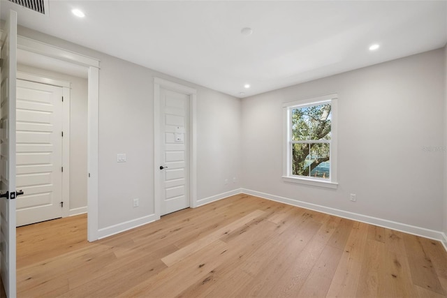 unfurnished bedroom with light wood-type flooring