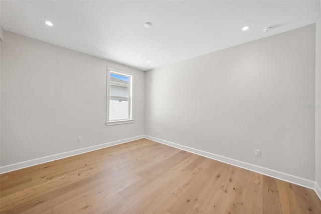 unfurnished room with light hardwood / wood-style floors