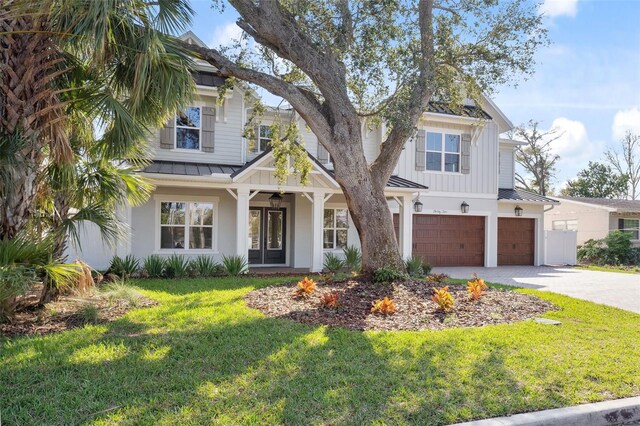 view of front of home featuring a garage and a front lawn