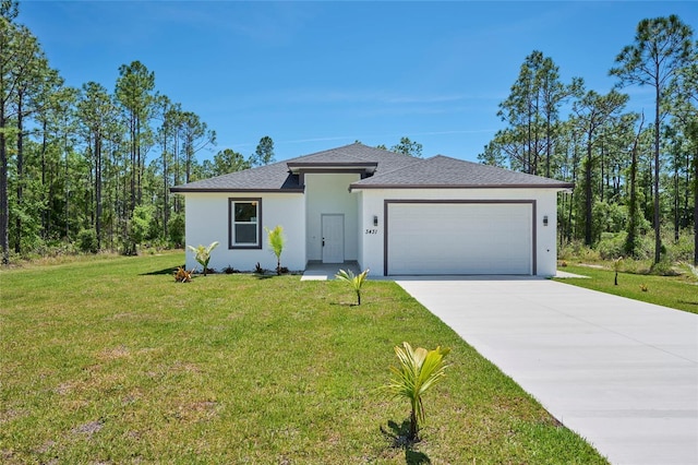 view of front of home with a front lawn and a garage