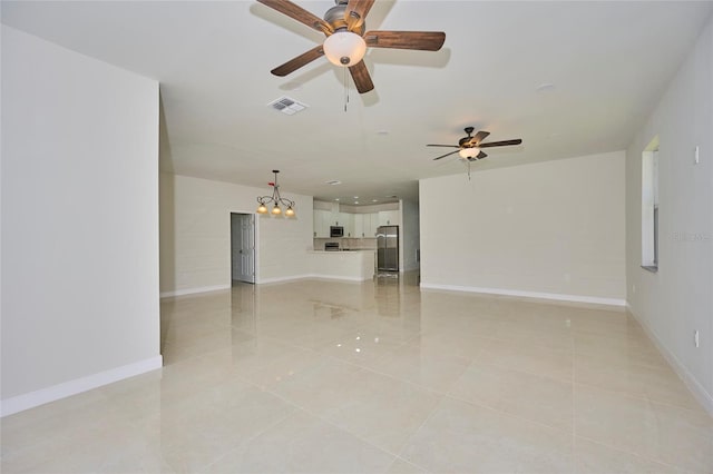 unfurnished living room with ceiling fan with notable chandelier and light tile floors