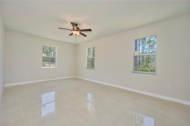 tiled spare room featuring ceiling fan