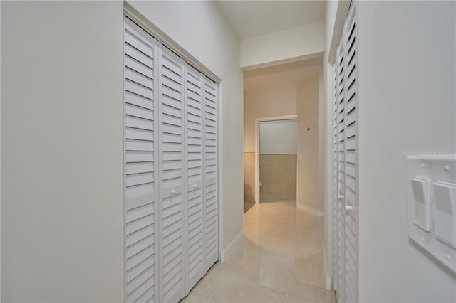 hallway featuring light tile flooring