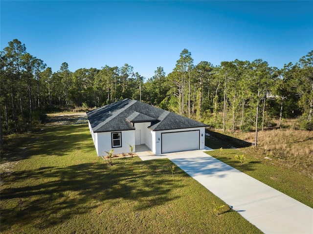 view of front of house featuring a garage and a front lawn