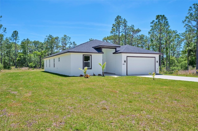 view of front of home featuring a garage and a front lawn