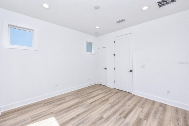 empty room with light hardwood / wood-style floors