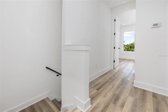 hallway with light hardwood / wood-style floors