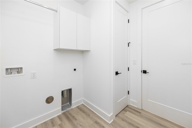 clothes washing area with electric dryer hookup, cabinets, hookup for a washing machine, and light hardwood / wood-style flooring