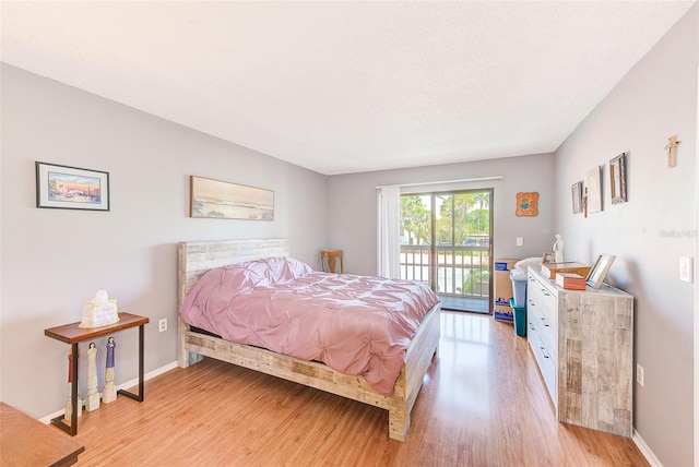 bedroom featuring light hardwood / wood-style floors and access to outside