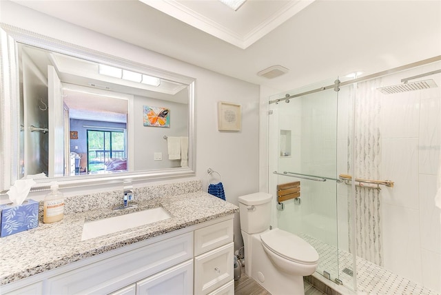 bathroom with crown molding, vanity, toilet, and a shower with shower door