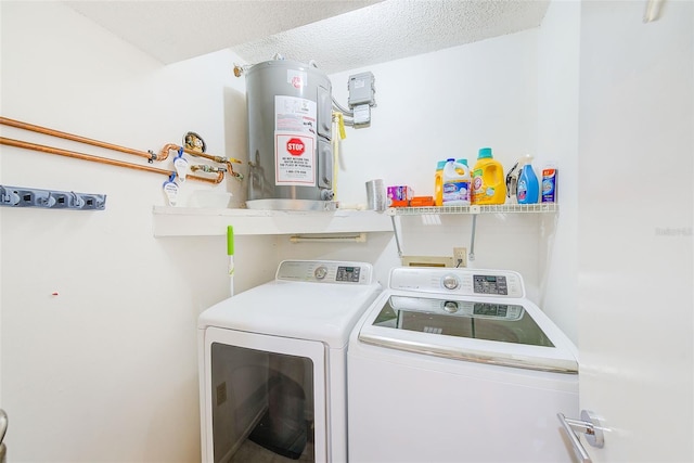 clothes washing area with a textured ceiling, water heater, washing machine and dryer, and washer hookup