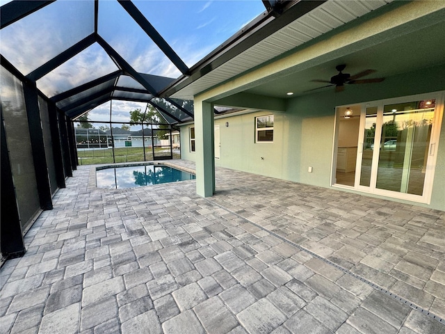 unfurnished sunroom featuring ceiling fan and a swimming pool