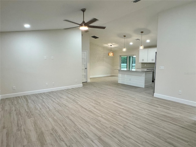 unfurnished living room featuring ceiling fan and light wood-type flooring