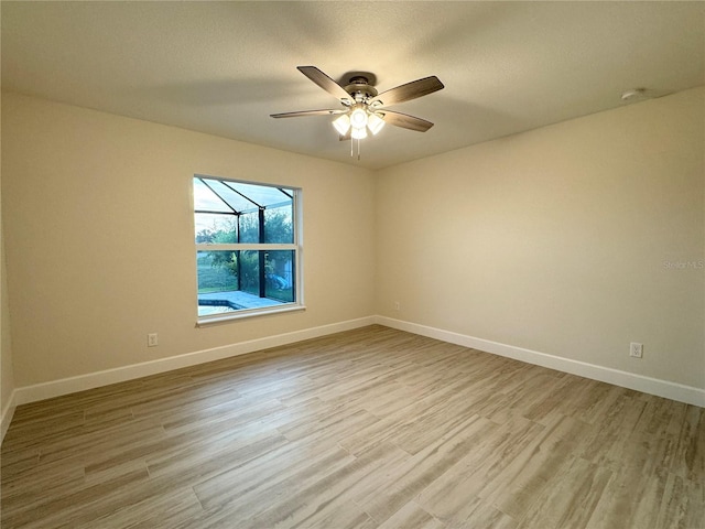 empty room featuring light hardwood / wood-style floors and ceiling fan