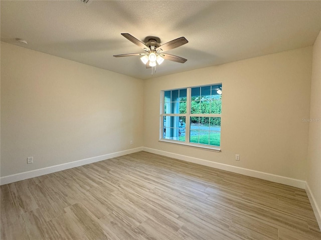 spare room featuring ceiling fan, a textured ceiling, and light hardwood / wood-style flooring