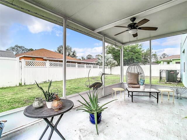 sunroom / solarium featuring ceiling fan