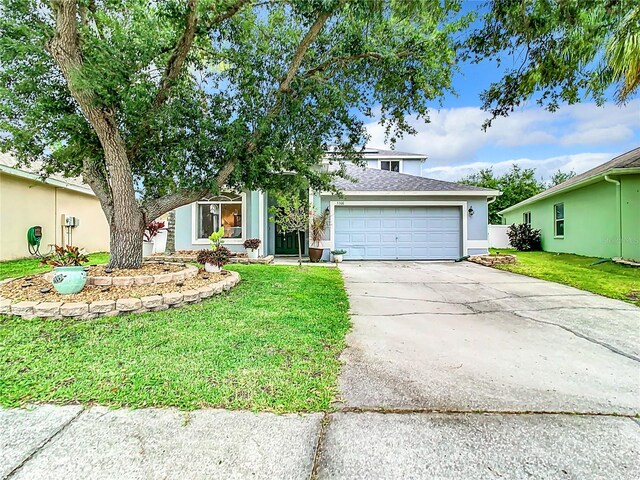 view of front of house with a garage and a front yard