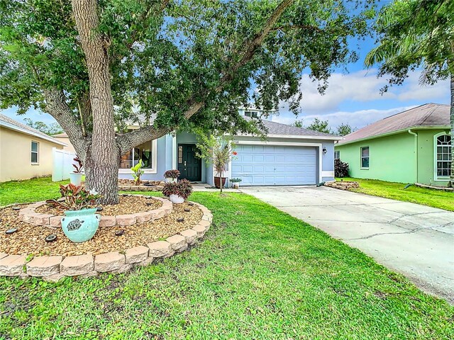 single story home featuring a garage and a front lawn