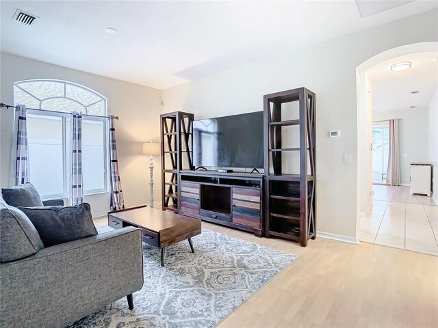 tiled living room with plenty of natural light