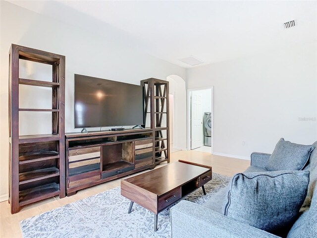 living room featuring light hardwood / wood-style flooring and washer / clothes dryer