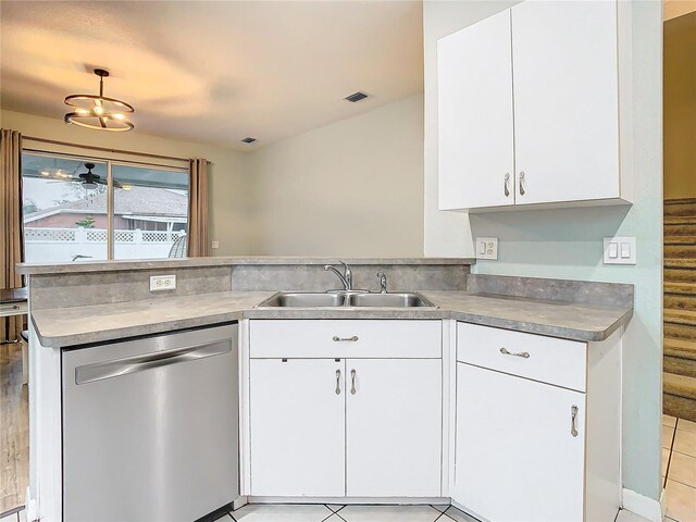 kitchen featuring light tile floors, sink, white cabinetry, stainless steel dishwasher, and kitchen peninsula