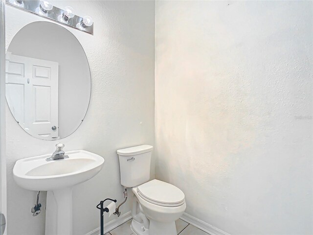 bathroom with tile floors and toilet