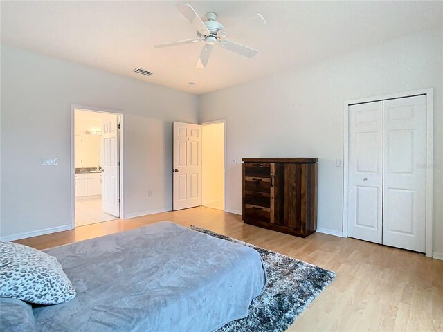 bedroom with a closet, ceiling fan, and light hardwood / wood-style flooring