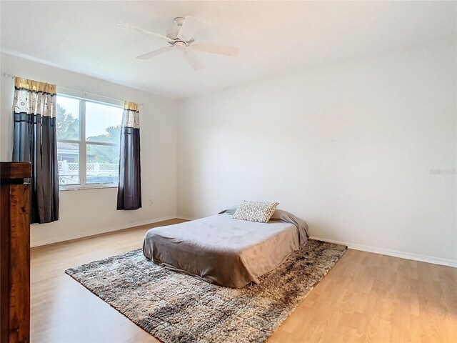 bedroom with light hardwood / wood-style floors and ceiling fan