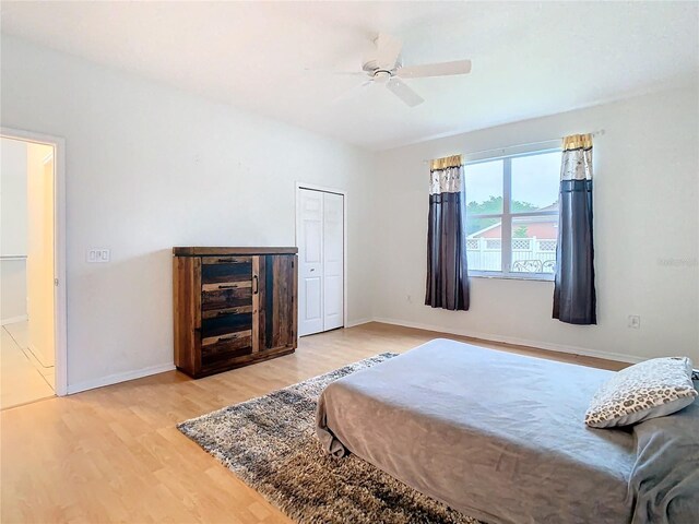 bedroom featuring a closet, ceiling fan, and light hardwood / wood-style flooring