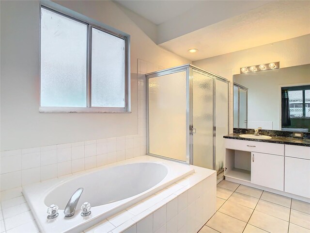 bathroom with a wealth of natural light, large vanity, and shower with separate bathtub