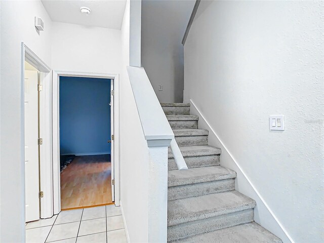 staircase with light tile floors