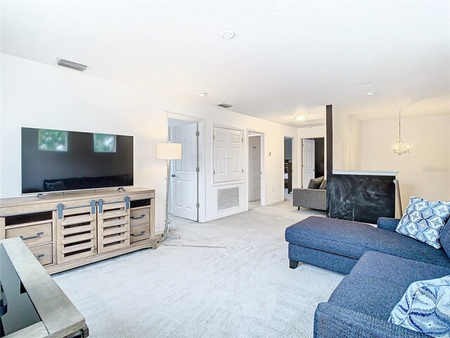 living room with a chandelier and light colored carpet