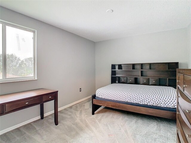 bedroom featuring light colored carpet