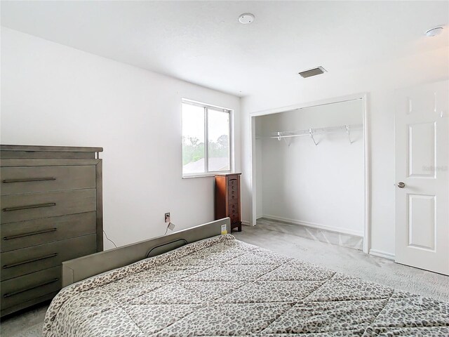 carpeted bedroom with a closet