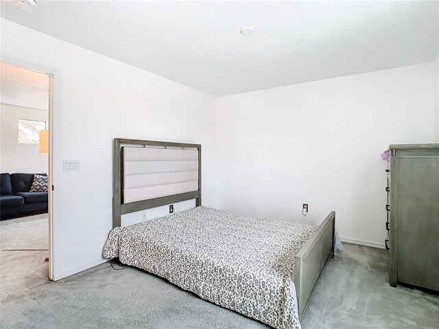 bedroom featuring light colored carpet