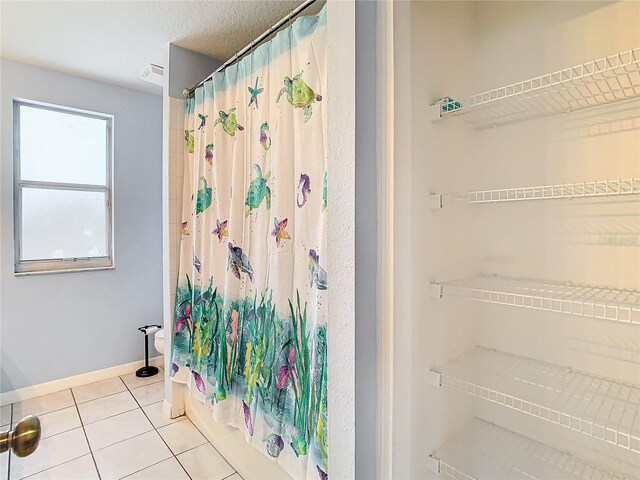 bathroom with tile flooring