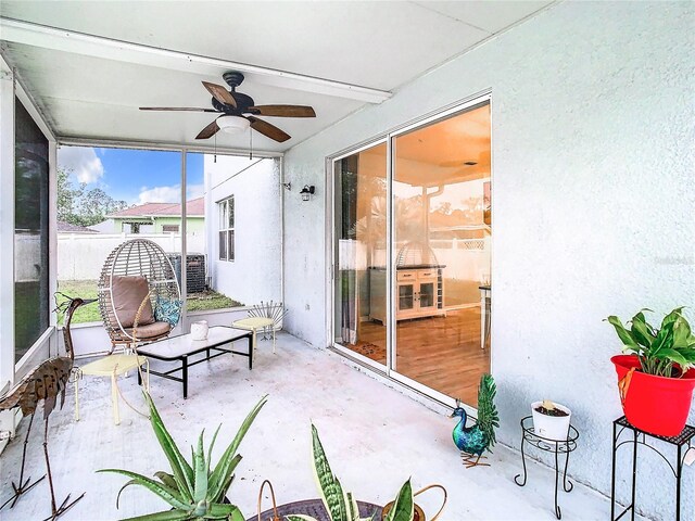 sunroom / solarium featuring ceiling fan