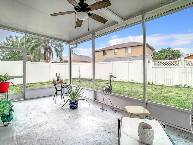 sunroom featuring ceiling fan