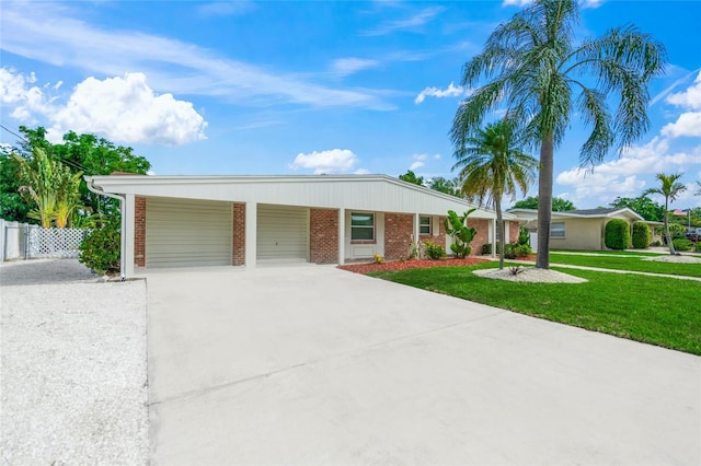 single story home featuring a garage and a front yard